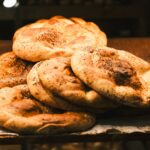 a pile of bagels sitting on top of a table